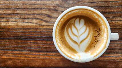 Top view latte art coffee on wood background