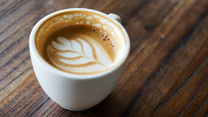 Top view latte art coffee on wood background