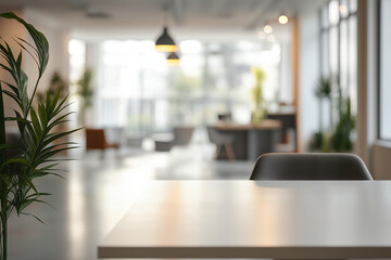 A white table with a plant in front of a modern office space