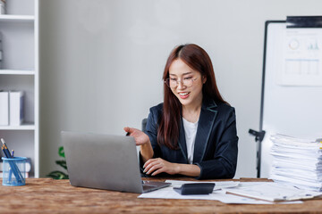 Business financing accounting banking concept. Business woman hand doing finances and calculate on desk about cost at home office. Woman working on desk with using calculator, finance accounting.
