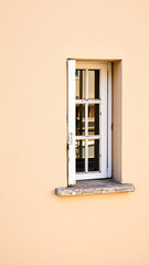 White window on a pale orange wall
