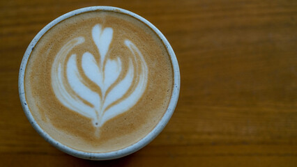 Top view latte art coffee on wood background