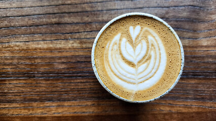 Top view latte art coffee on wood background