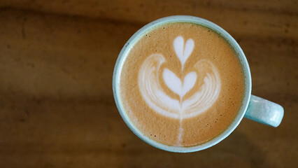 Top view latte art coffee on wood background