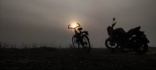 silhouette of a cycle and a bike