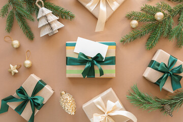 A beautifully decorated Christmas gift box with a blank white paper tag among the various Christmas ornaments.