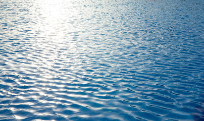 Water in swimming pool rippled water detail background.  Blue in the water in the swimming pool.