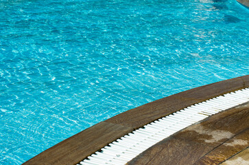 Water in swimming pool rippled water detail background.  Blue in the water in the swimming pool.