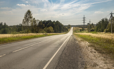 A long road with a few trees in the background