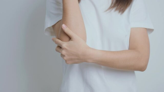 Woman having elbow ache at home, muscle pain due to lateral epicondylitis or tennis elbow. injury, Health and medical concept
