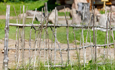 A wooden fence made of sticks and branches