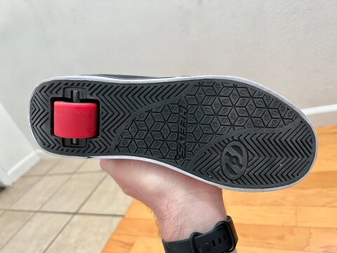 Bottom of a Heely's brand shoe with a roller wheel on the heel.