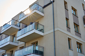 Multi story apartment building exterior. Residential building facade with balconies at summer day....
