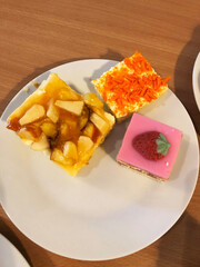 Sweet cakes and pastries on a buffet plate.