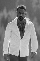 Portrait of the latin handsome man outdoor. A Hipster guy model headshot. Male face. Handsome man. Confident male model. Hispanic Man looking proud. Closeup face of attractive man. Elegant guy.