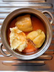 directly above shot of Croatian food, stuffed peppers in tomato sauce with mashed potato 
