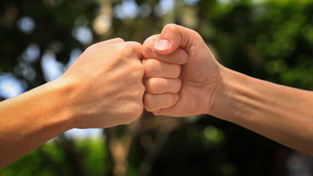 Deal of teamwork with the Man hand a fist bump commit as get together in the office