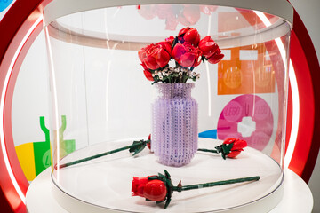 Fototapeta premium London, UK - July 26, 2024: Huge Lego sculpture of a red roses in vase at the Lego shop in Copenhagen Airport. Legos are interlocking plastic bricks.