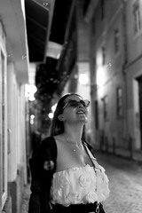 Naklejka premium Woman in glasses with pink hearts blows soap bubbles.