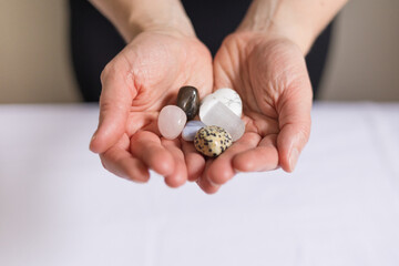 Close up of woman's hands holding crystals for energy healing Reiki