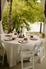 Riverside wedding guest seating with rustic tableware