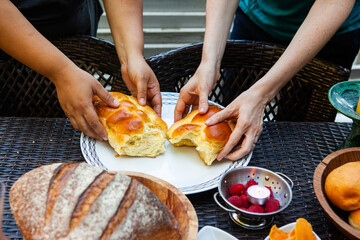 two diverse women break bread together