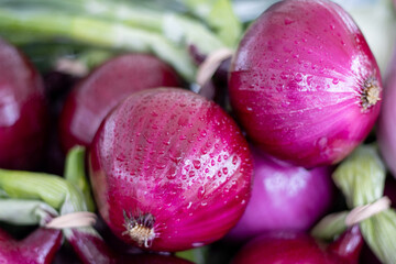 Close-up of red onions with water droplets at a farmers market