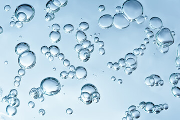 Close up macro Aloe vera gel cosmetic texture blue background with bubbles. Lemongrass gel skincare product. antibacterial liquid with aloe vera, moisturizing. Safe and environmental friendly.