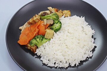 Stir Fried Mixed Vegetable and Plant Based Crispy Pork with Rice, close up angle view