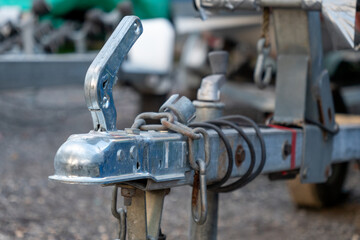 A rusty chain is attached to a trailer hitch