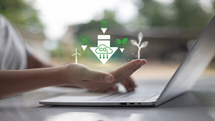 A person is holding a green icon on it that says "down".