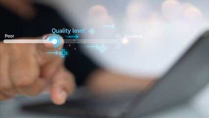 A person is pointing at a laptop screen with a quality level indicator