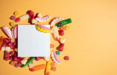 Various creepy candy sweets for Halloween Trick or treat on yellow background with white space for text