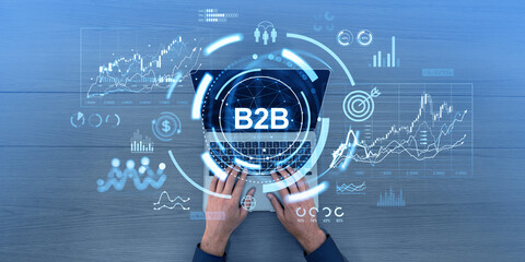 Businessman hands typing on laptop, b2b icons hologram dashboard