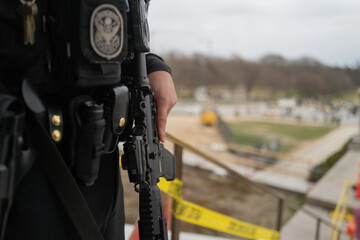Police officer wearing uniform with gun in The Washington Monument. Police officers in Washington...