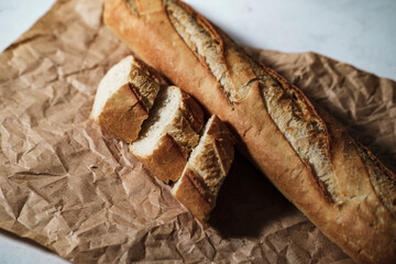 french baguette fresh, cut in slices, in kitchen textile cloth, rustic sryle