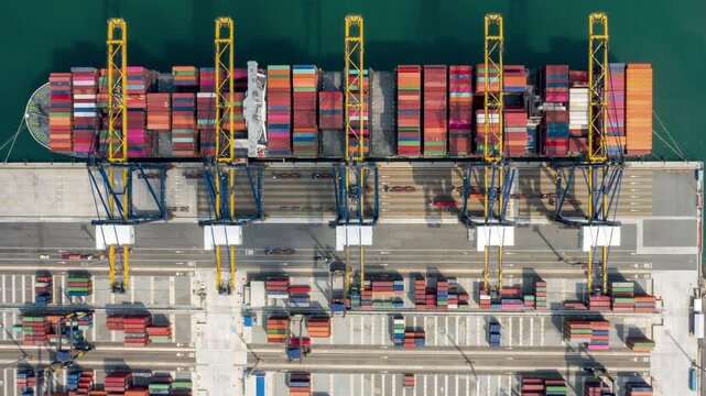 Aerial Time-lapse showing a container ship navigating into a busy industrial port