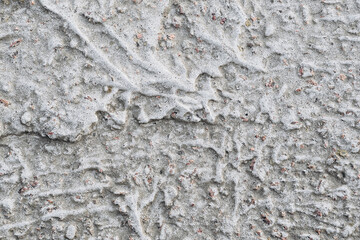 Textured concrete surface shows unique patterns from natural wear and weathering over time