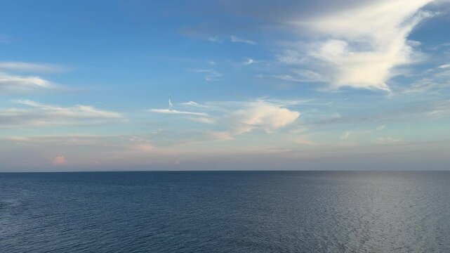 Clouds over the sea blue calm waters.