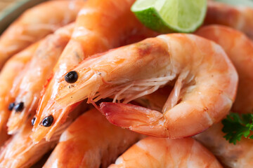 Delicious shrimps with lime on plate, closeup view