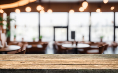 Empty wooden table in a cafe setting with blurred background.