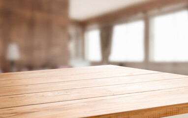 Empty wooden tabletop with a blurred background of a living room.