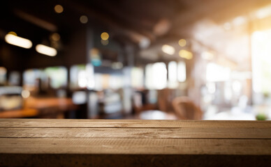 Empty wooden table with blurred background of a cozy cafe.