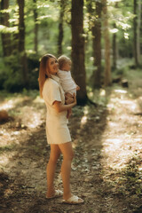 A mother and daughter walking in the forest