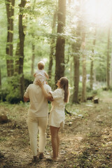 a young family on a walk in the woods