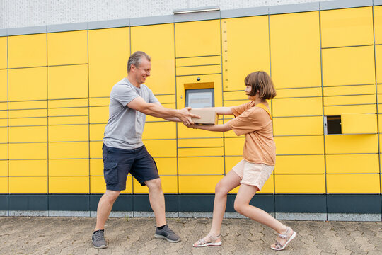 Father and daughter snatching parcel from each other near terminal