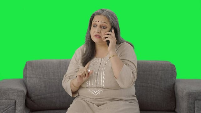 Angry Indian old woman shouting on phone Green screen