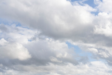 Fluffy white clouds, against a bright blue sky, with little editing.