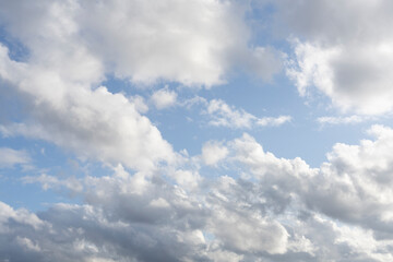 Fototapeta premium Fluffy white clouds, against a bright blue sky, with little editing.