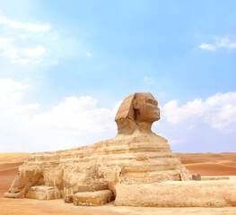 Famous Great Sphinx and sand dunes, Cairo, Egypt. Statue of Sphinx, mythical creature with head of man and body of lion, Giza complex (Giza Necropolis)